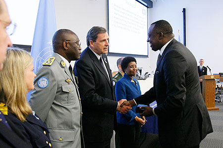 Ambassador Eugene Gasana receiving the medals on behalf of the fallen servicemen (Courtesy Photo)