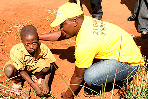 MTN staff engage Cyimbazi Primary pupil in tree planting exercise (Photo by S. Rwembeho)