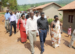 Deputy Speaker Denis Police (2right) and Kicukiro District vice Mayor Florence Uwayisaba (R) lead the tour of Igisubizo village (Photo J Mbanda)