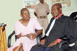  Victoire Ingabire chats with her Lawyer, Gatera Gashabana,  in court yesterday. (Photo J Mbanda)