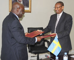 Minister Rwangombwa (R) and SIDA country representative,Richard Bomboma after signing of the grant yesterday. (Photo J Mbanda)