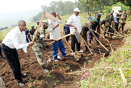 Defence Minister, James Kabarebe (L), with other leaders including Local Government Minister, James Musoni (standing with cap), at the launch of Army Week activities yesterday. (Photo J Mbanda