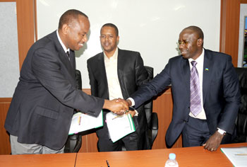 Infrastructure Minister Albert Nsengiyumva (L) shakes hands with Education Minister Pierre Damien Habumuremyi after handing over to Jerome Gasana (C) as the new Director General of Workforce Development Authority on Thursday. (Photo J Mbanda) 