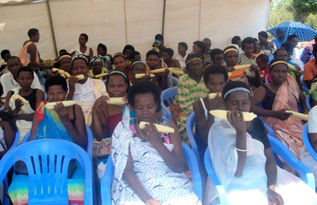 Women exhibiting maize during a ceremony (Photo. S. Rwembeho)