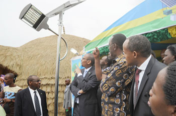 Prime Minister Bernard Makuza and other leaders look at solar powered lights as they tour the 2011 Expo on Friday. The New Times John Mbanda.