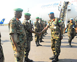 Lt. Gen. Ceasar Kayizera (2nd L) welcomes Col. Emmanuel Karemera and his contigent back to the country The New Times /John Mbanda.