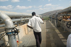 An employee of EWSA inspecting a water treatment plant. The New Times/ File.