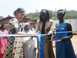 ICRC's Cisse Tanja Timona (L) and Rusizi Vice Mayor,Francoise Nirere (2nd R), cut ribbon at inauguration. The New Times / L.Nakayima)