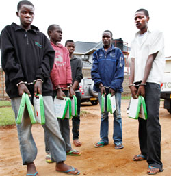 The culprits paraded with the stolen laptops. The Sunday Times / Timothy Kisambira