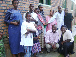 Benilde Uwababyeyi (extreme R) and other officials join the children and their mother for a group photo. The Sunday Times / Grace Mugoya.