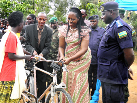 Governor Aisa Kirabo Kacyira (middle) handing a bicycle to a woman member of the CPCs as IGP Emmanuel Gasana looks on. The Sunday Times / Stephen Rwembeho