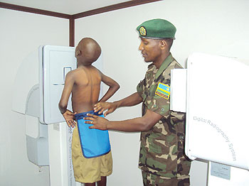 2nd Lt. Dr. Emmanuel Nkurunziza examines a child in a radiography mobile clinic. The New Times / D. Sabiti