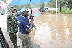 Premier Pierre Damien Habumuremyi (R) wth Chief of defence staff Lt. Gen. Charles Kayonga looking at the flooded section of the highway at Nyabugogo. The Sunday Times/J. Mbanda.