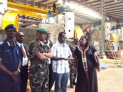Eng.Dominique Rwizinkindi  (2L) showing Eastern province Governor (R) some parts of the granite factory as security officials look on. The New Times / D. Ngabonziza.