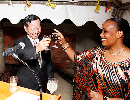 Amb Jacqueline Mukangira (L) of the Ministry of Foreign Affairs toasts with Amb Kunio Hatanaka. The Sunday Times /Timothy Kisambira