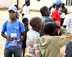 A vendor selling Tigo airtime: The Telecom Company is providing scholarships to support education for all. The New Times / File