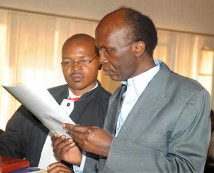 Leon Mugesera (R) with his Lawyer Donat Mutunzi in Court in Nyamirambo yesterday. The New Times / John Mbanda.