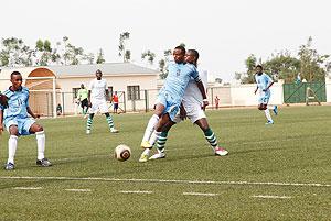 Isonga captain Emery Bayisenge holds off a Kiyovu player during a Primus League encounter. Isonga take on  Rayon Sport this afternoon.  The New Times / T. Kisambira.