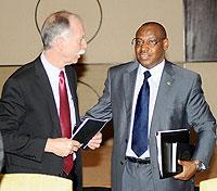 Richard Newfarmer (left),International Growth Centre Country Director for Rwanda speaks to Central Banku2019s Governor Claver Gatete during the Second Growth Forum  held in Kigali on Tuesday. The New Times /  T.Kisambira.