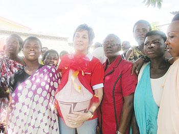 Joanna Kerr Chief Executive of ActionAid (C) holding a gift that she was given by women from Nyanza District. The New Times / D. Umutesi.