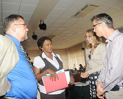 PSCBS Executive Secretary Stella Mugabo (C) talks to members of the development community on the sidelines of  the workshop. The New Times / J. Mbanda.