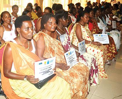 The women proudly exhibit their certificates yesterday. The Sunday Times / T. Kisambira.