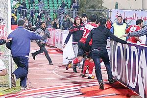 This file photo shows fans of Al-Masry team running after players of the Al-Ahly team during riots that erupted after the football match between the two teams in Port Said, on February 2. Net photo