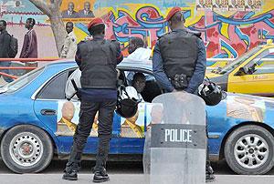 Senegalese police officers patrol Obelisk Square in Dakar on February 14, 2012, to prevent opposition supporters from settling in the square where they planned a permanent sit-in protest. Net photo