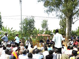 Province leaders and Kiziguro residents take part in a fierce debate before the 80 year old tree was cut down. The Holy Tree can be seen in the background.  The New Times / Stephen Rwembeho.