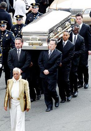 Carolyn Whigham leads pallbearers to the hearse with the body of Whitney Houston after the rousing funeral service at New Hope Baptist Church in Newark.