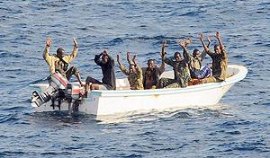 Suspected pirates keep their hands in the air as directed by sailors aboard the guided-missile cruiser USS Vella  Gulf (CG 72) (not shown), in the Gulf of Aden. File photo