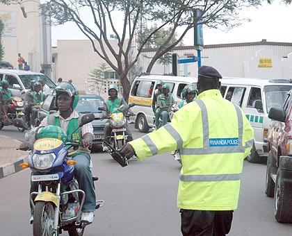 Enforcing order: A traffic police officer directs traffic on a busy Kigali junction.  The New Times / File.