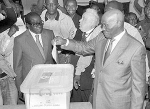 Senegalu2019s President Abdoulaye Wade casts his vote at the polling station in the suburb  of Point E in Dakar. Net photo