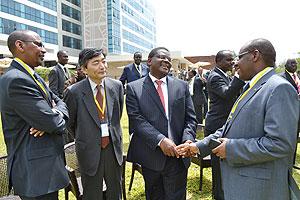 L-R: Finance minister John Rwangombwa, IMF deputy managing director Naoyuki Shinohara, Acting Kenyan Minister of Finance, Robinson Githae, and the Rwanda National Bank Governor, Claver Gatetes, share a light moment after the opening of the conference in A