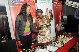 Girls serve spirits at the launch ceremony. The New Times / J. Mbanda.