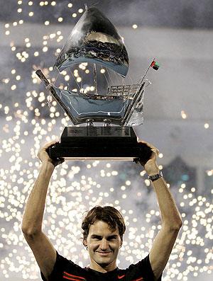 Switzerland's Roger Federer holds his trophy after beating Britain's Andy Murray in their ATP Dubai Open final tennis match in the Gulf emirate. Net photo.