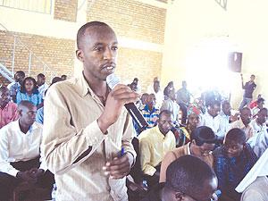 A participant makes a point on customer care during Friday's function in Gisagara District.  The New Times / JP Bucyensenge.