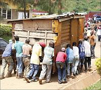 People relocate a spare kiosk following eviction from Gastata. The incubation centre will train mechanics. The New Times / File.