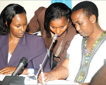 The Minister of Gender and Family Promotion, Aloysea Inyumba (R), Executive Secretary, National Women Council, Christine Tuyisenge (C) and the Council chairperson,  Francisca Tengera; consult during the news conference in Kigali yesterday. The New Times/ 