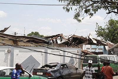 Damaged cars and shops are seen after explosions. Xinhua.