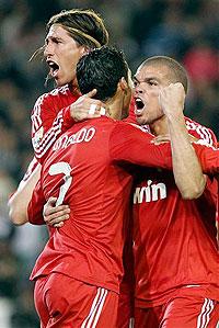 Cristiano Ronaldo (c) celebrates with teammates, Pepe and Sergio Ramos after scoring against Betis on Saturday. Net Photo