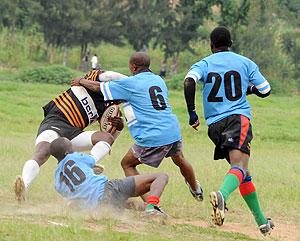 Sharks players take down a Buffalo player in an earlier tournament. The New Times / Timothy Kisambira.