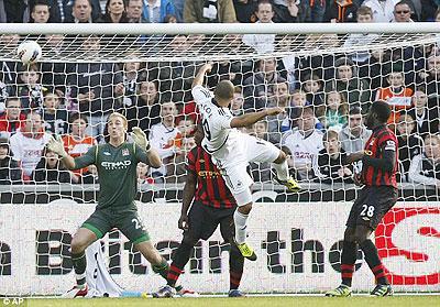 Putting his head on it: Moore gets his goal to earn Swansea the win against Manchester City. Net photo.