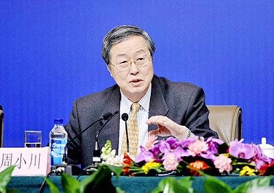 Zhou Xiaochuan, governor of the People's Bank of China (PBOC), answers questions from journalists during a press conference on monetary policy and financial reform in Beijing