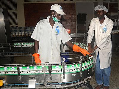 Workers of Inyange Industriesu2019 milk processing unit. The New Times / File.