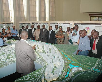 A city employee demonstrating its master plan to visitors at the one stop centre. Implementation is being hampered by lack of finances.  The New Times / File.