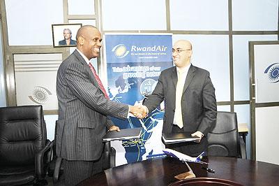 Bombardier Commercial Aircraft, president, Mike Arcamone, and RwandAir CEO John Mirenge after signing the agreement. The New Times/Courtesy.