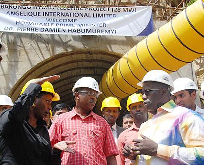 Prime Minister Pierre Damien Habumuremyi (R) with other officials inspect the construction site. The New Times / JP Bucyensenge.