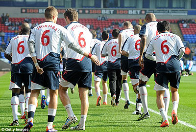 Bolton players warm up for the game wearing u2018Muamba 6u2019 jerseys. Net photo.