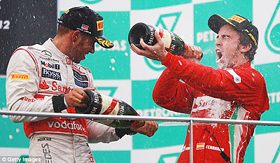 Fernando Alonso (right) celebrates his victory (above) after taking the chequered flag. Net photo.